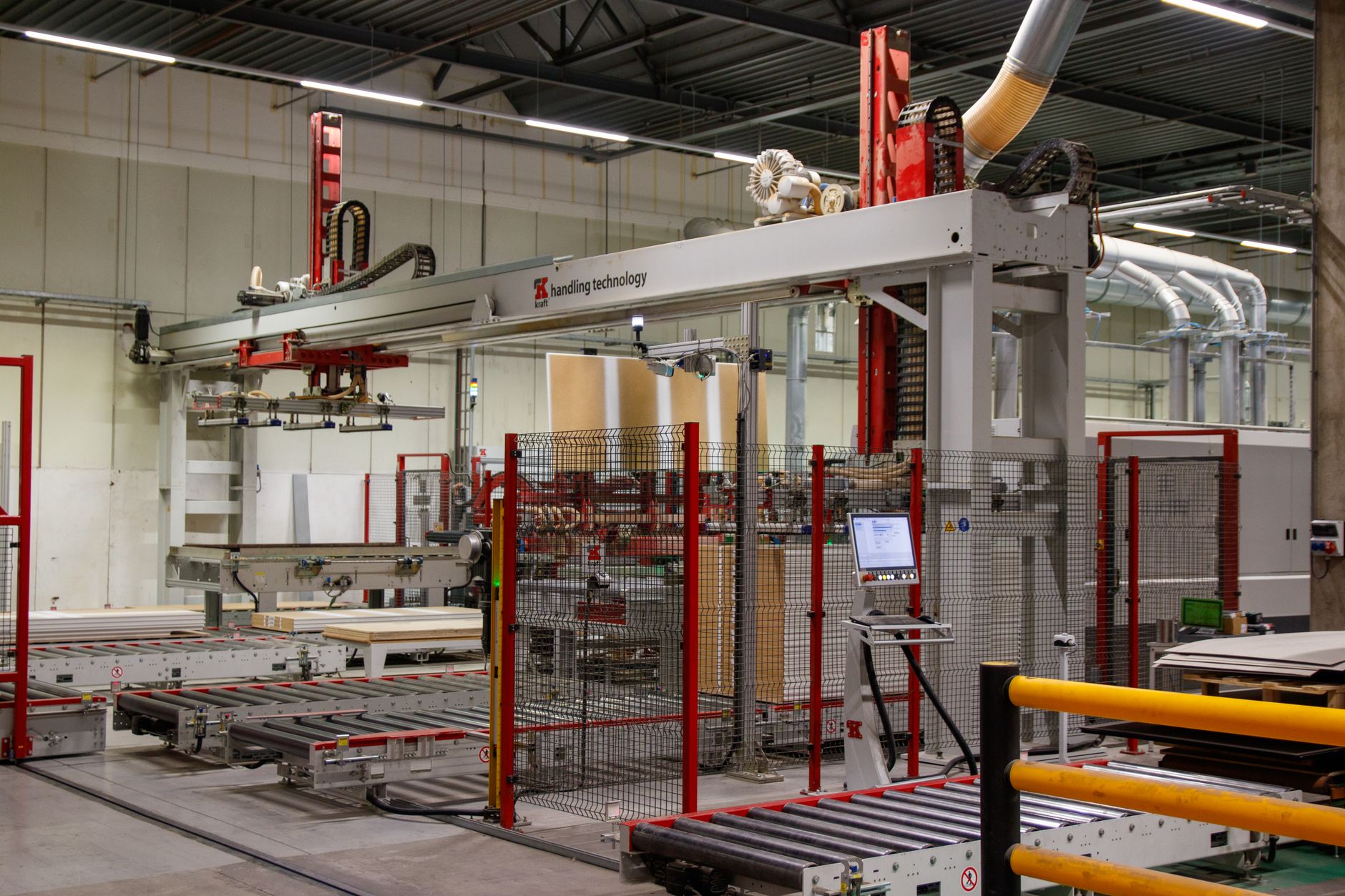 Automated assembly line with robotic arms positioned along a conveyor in a factory