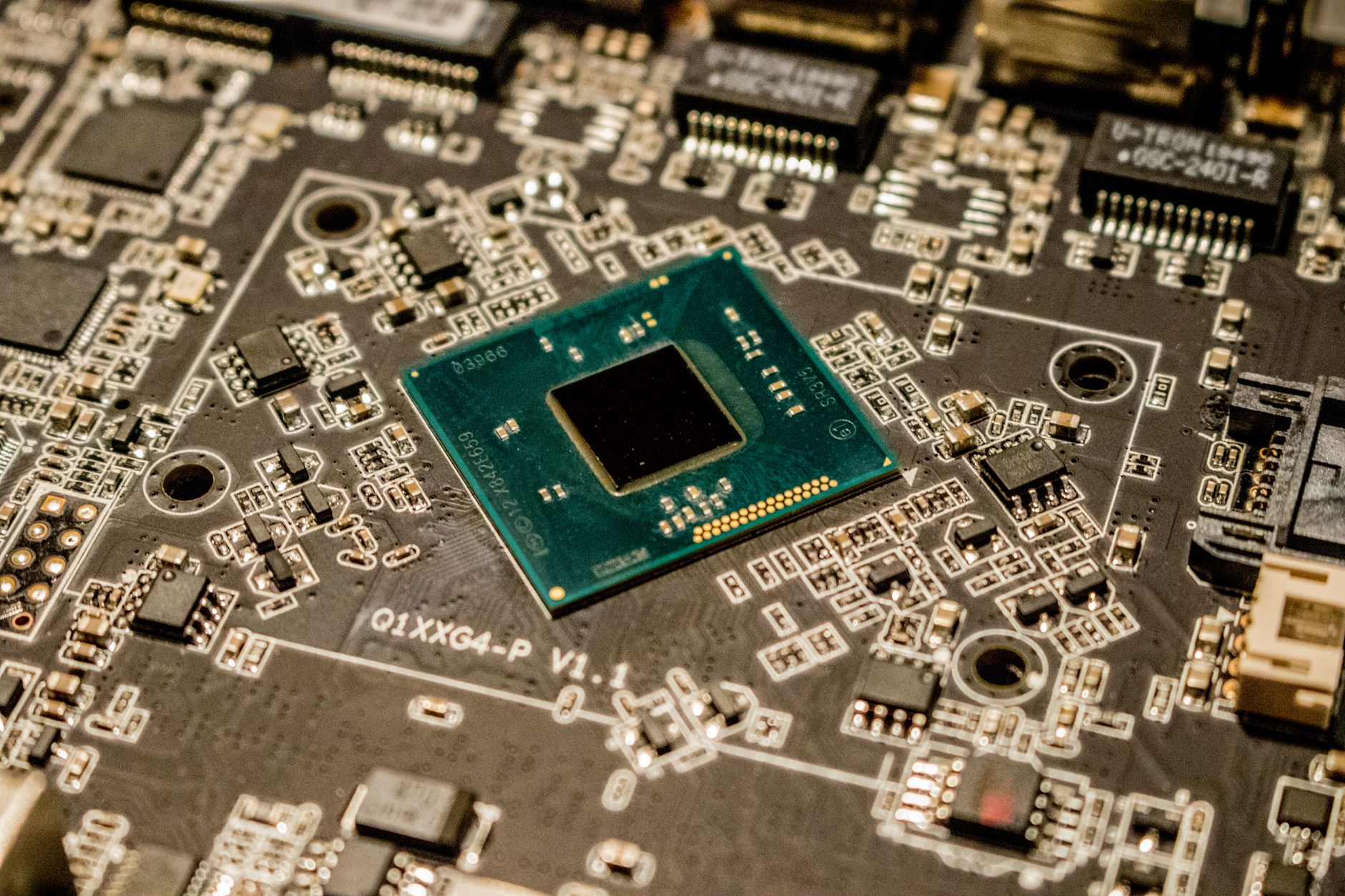 Close-up of a microchip on a printed circuit board with electronic components