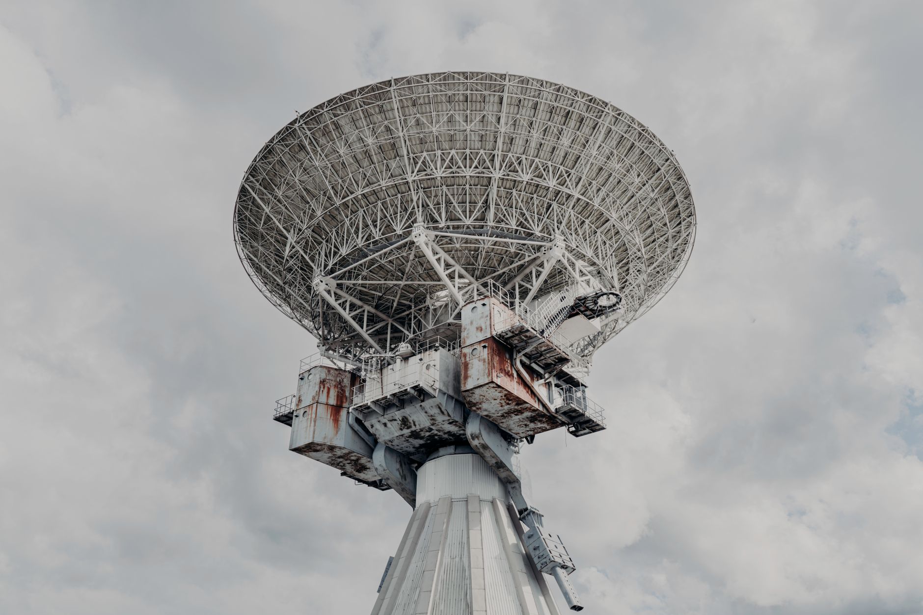 Array of satellite dishes pointed skyward against a clear blue sky